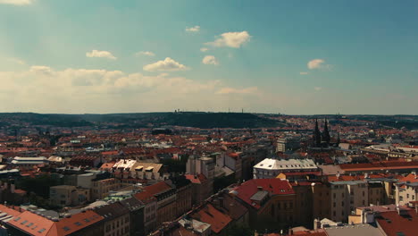 aerial fly down of namesti miru square in prague with the castle in the background