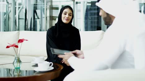 emirati male female business team using tablet downtown