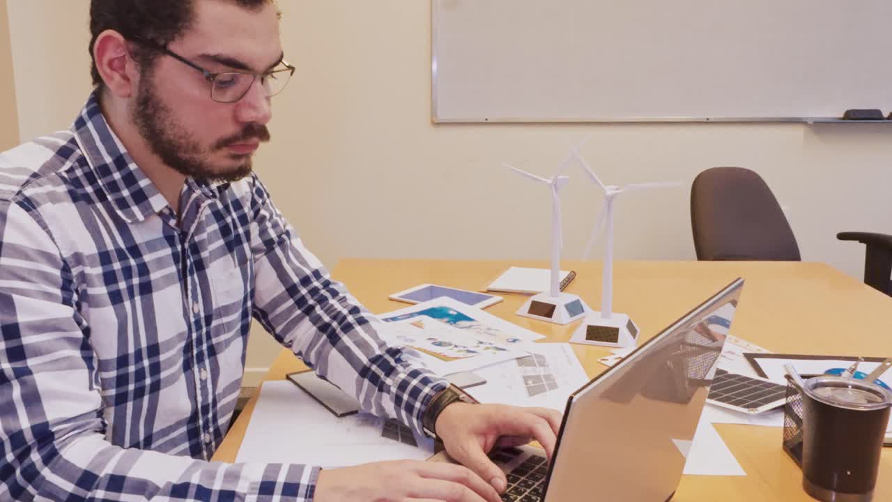 Focused Middle Eastern Professional Working on a Laptop Computer