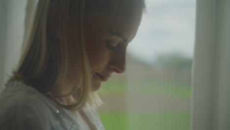 thoughtful woman staring out the window