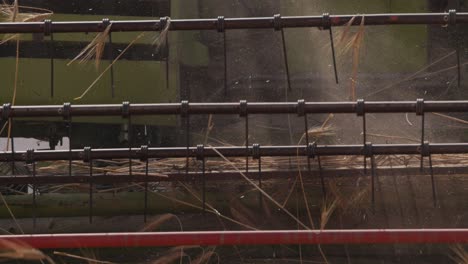 Slow-Mo-Close-Up-of-Combine-Harvester-Gathering-Wheat-in-Ukraine