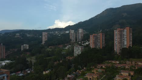 Drone-Flies-Away-from-Mountain-Above-Apartment-Buildings-in-Colombia
