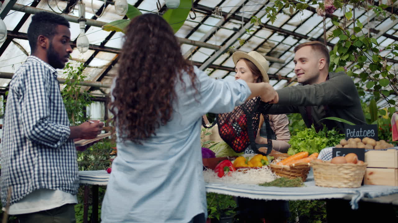 People Shopping at a Greenhouse Farmers Market