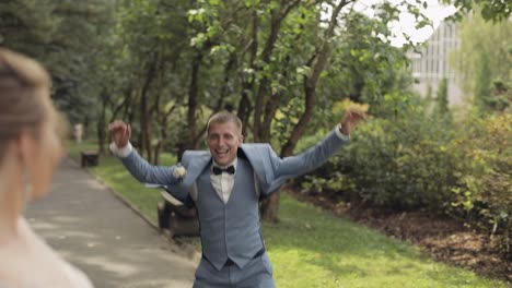 happy groom jumps for joy as he sees his bride for the first time on their wedding day