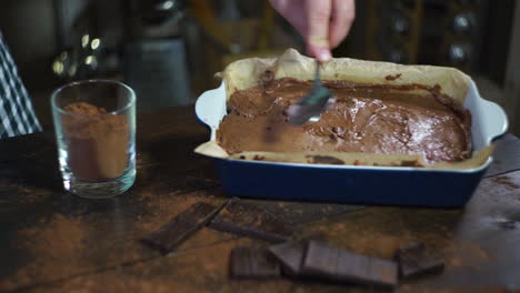 man cooking cake. chef preparing dough for baking chocolate cake