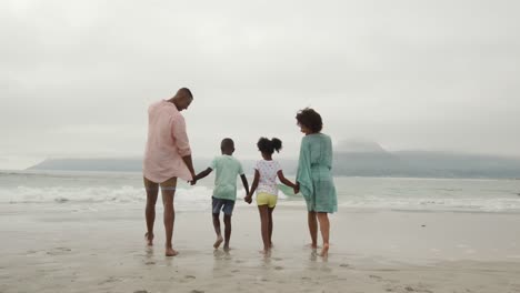 family enjoying free time by the sea