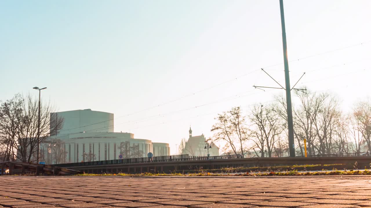 A Sun-rise Time-lapse of Traffic on A City Road ahead of the Opera Nova in Bydgoszcz Poland.