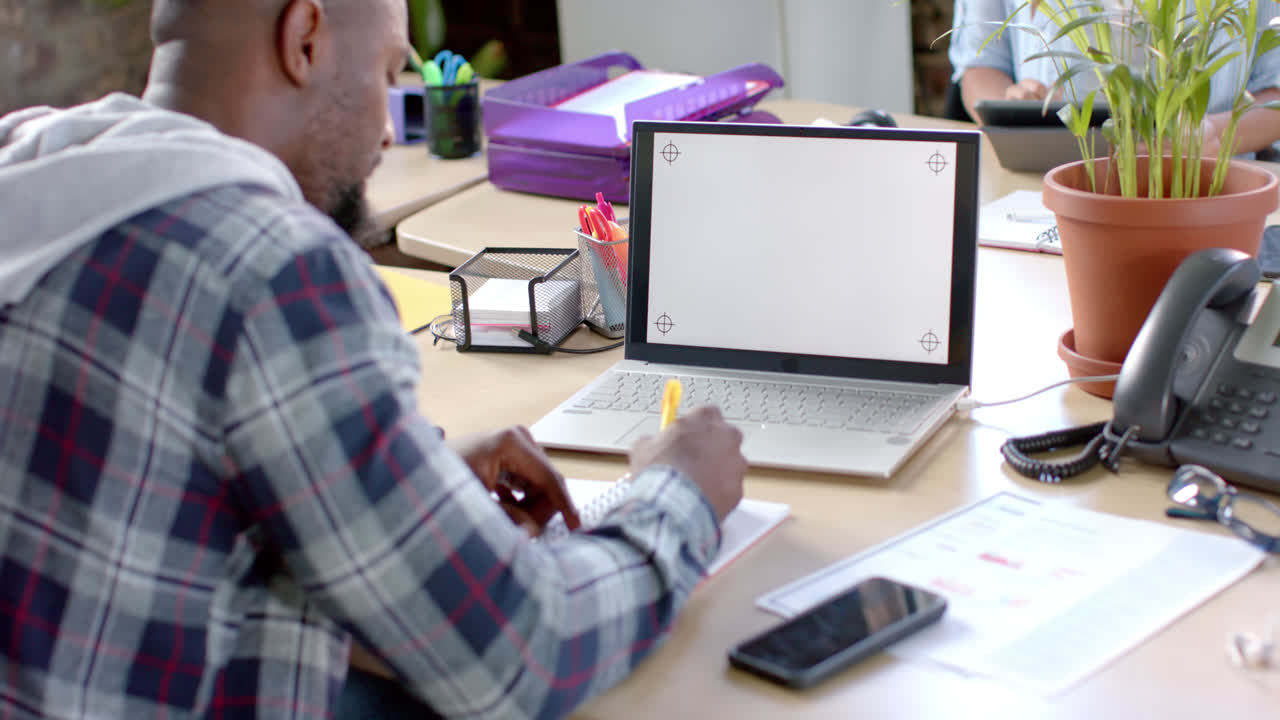 Focused african american casual businessman having laptop video call with copy space in slow motion