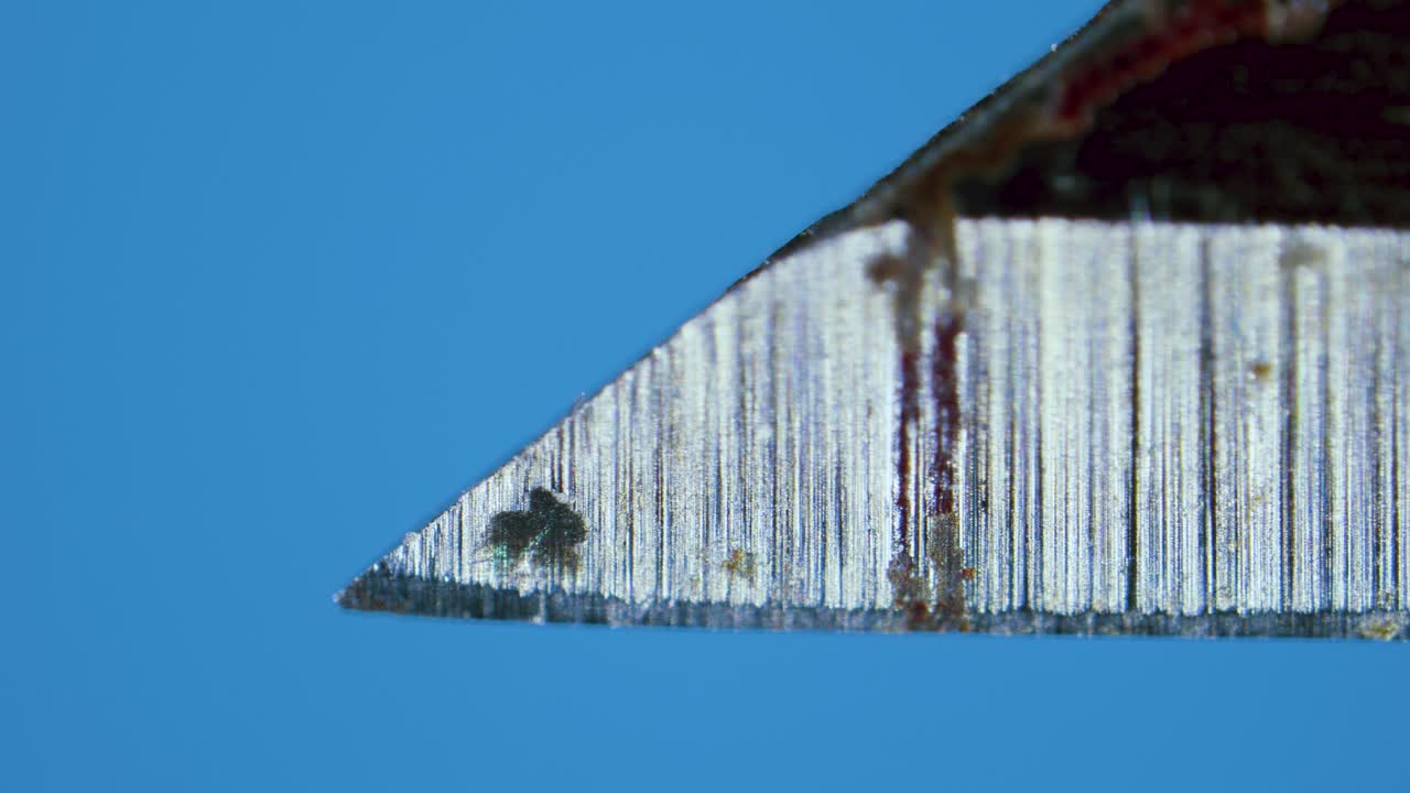 Surgical scalpel blade close up under microscope