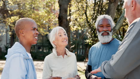 group of seniors talking and laughing in a park