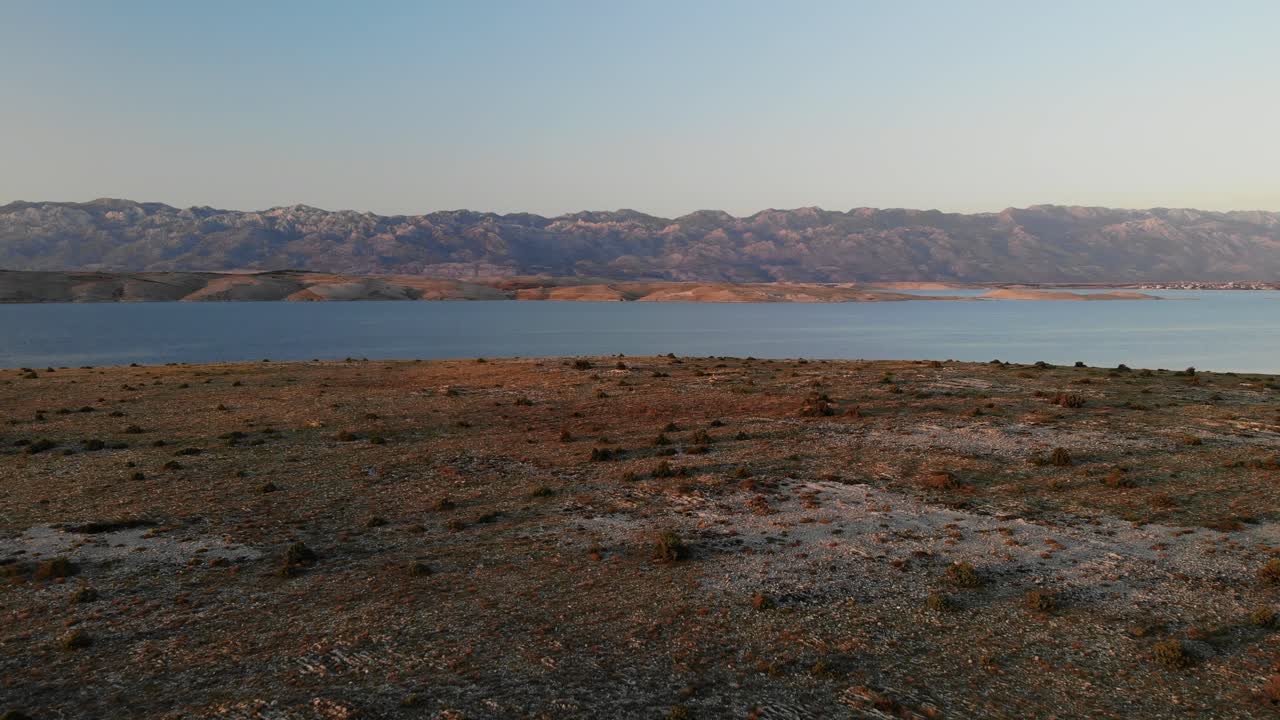 Approaching mountain and sea, aerial view in the evening