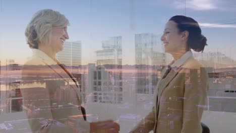 Animation-of-businesswomen-handshake-over-cityscape