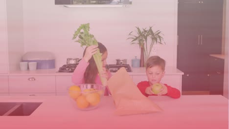 Caucasian-brother-and-sister-removing-vegetables-from-paper-bag-in-the-kitchen