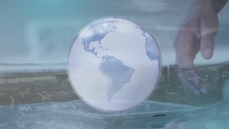 animation of globe and cityscape over caucasian businessman using tablet