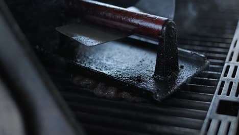 grilled beef patty on bbq grill with smoke