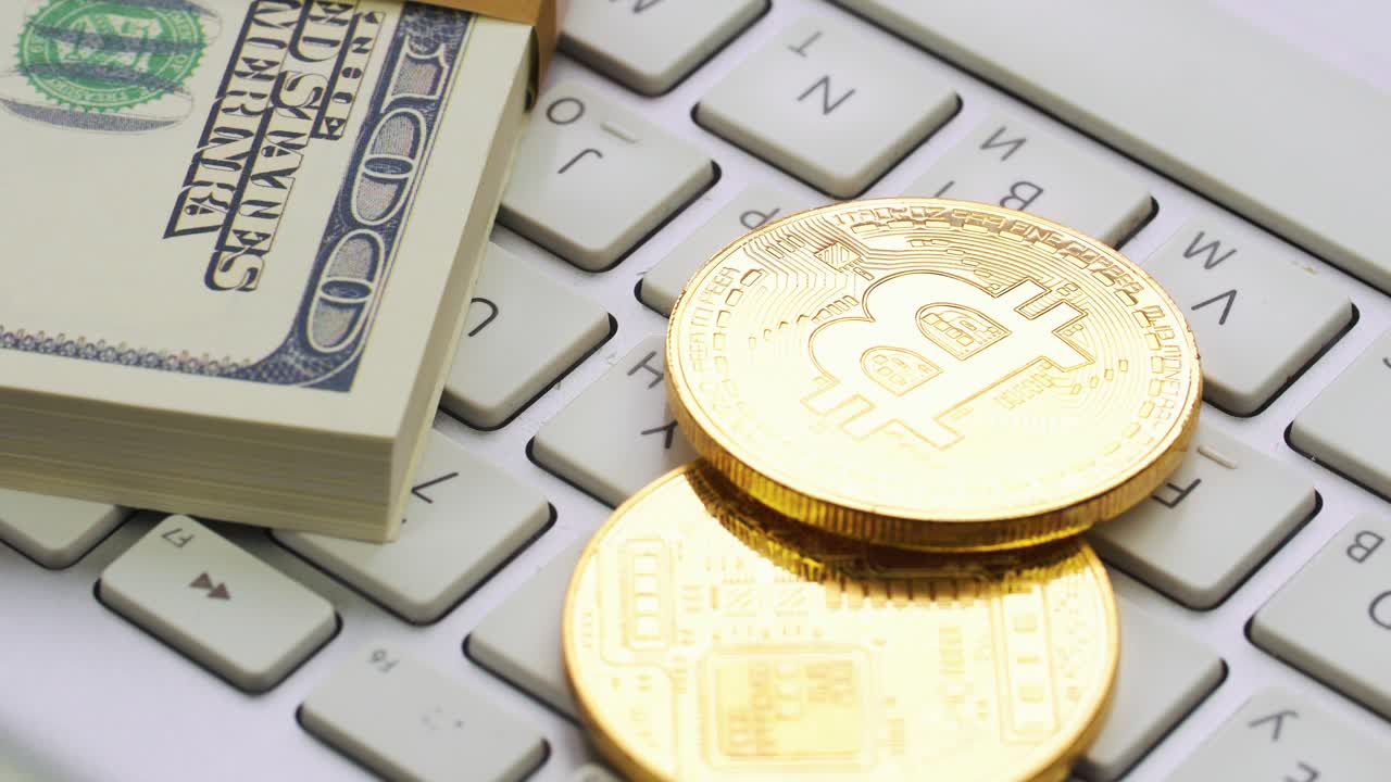 Bitcoin and Dollars on Keyboard