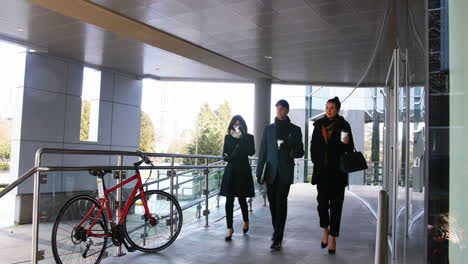 executives having coffee while walking