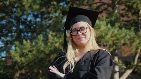 retrato de un joven graduado universitario en ropa y una gorra de graduación sonriendo mirando a la cámara