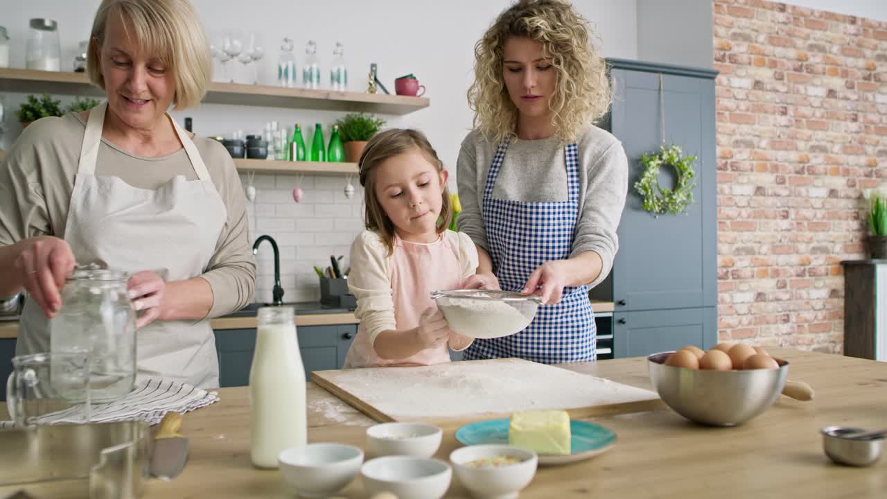 Video of women sift the flour for easter bake