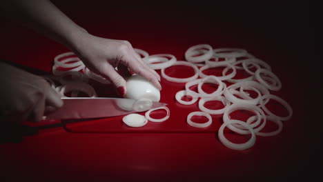 Wide-view-of-woman-hands-cutting-white-onion-into-slices.Female-slicing-onion.