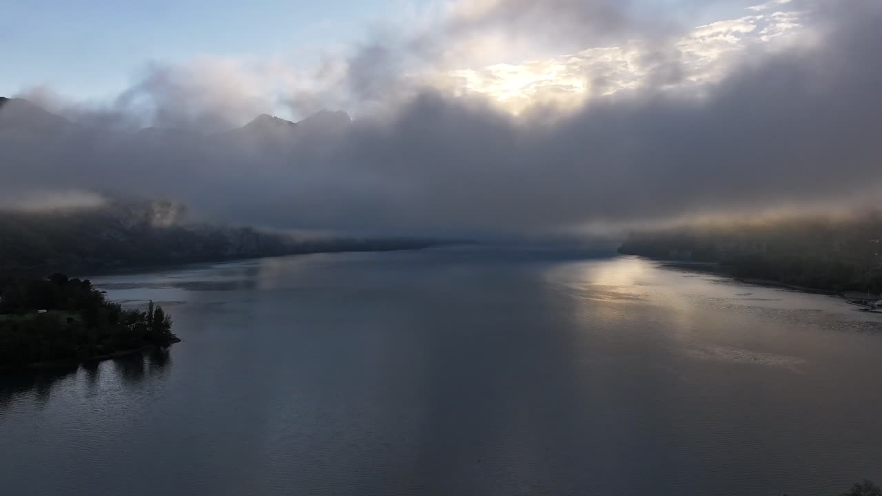 Misty Lake Sunrise: Serene Aerial Views of Mountains and Water