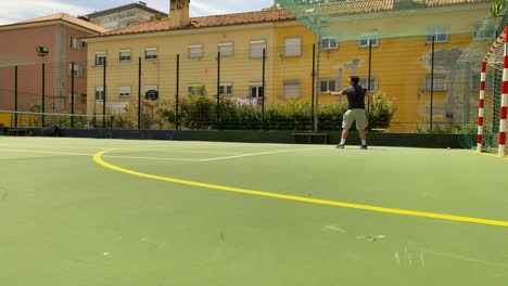 young man tennis player training on indoor court, practicing serve in lisbon, portugal