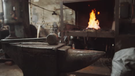 hammer on anvil in blacksmith workshop