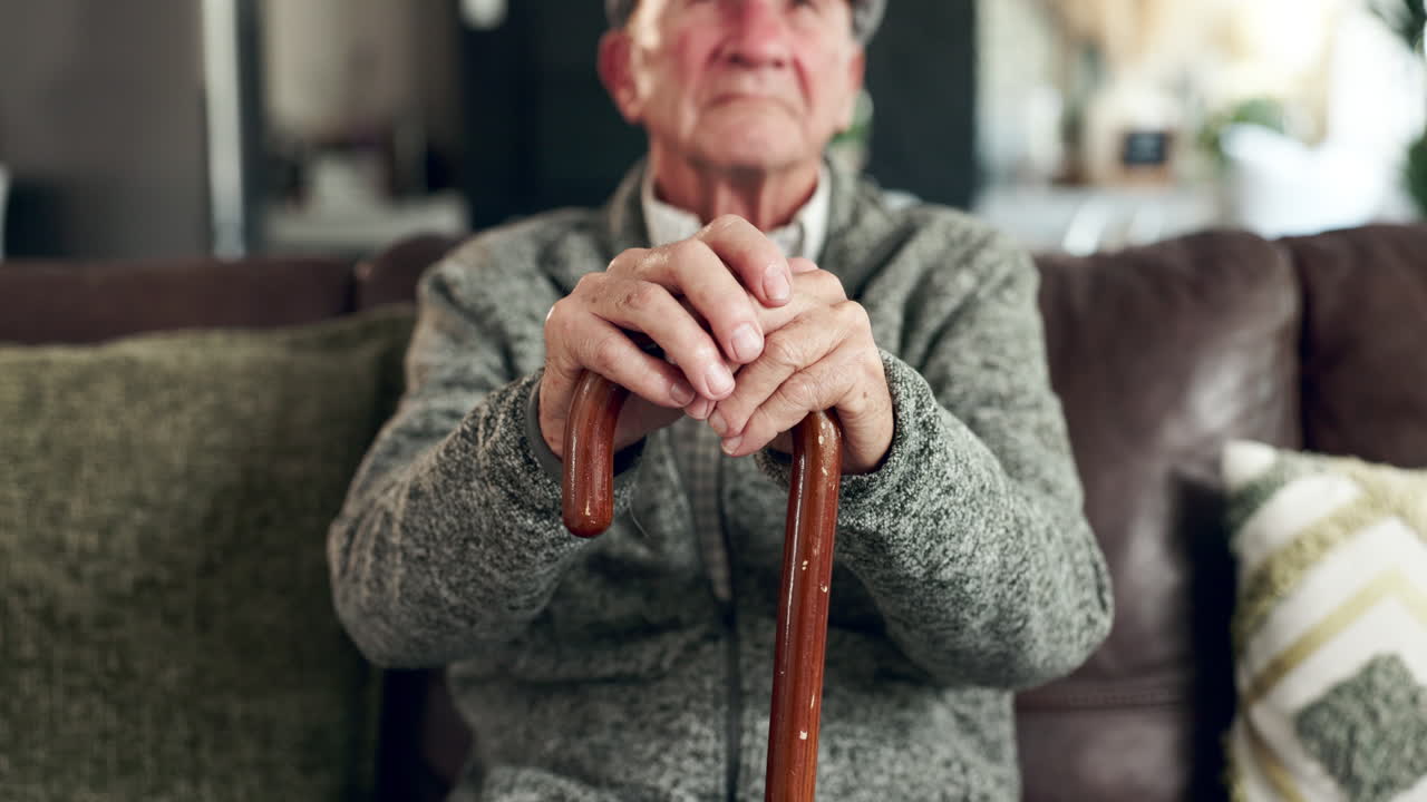 Elderly man resting with a cane