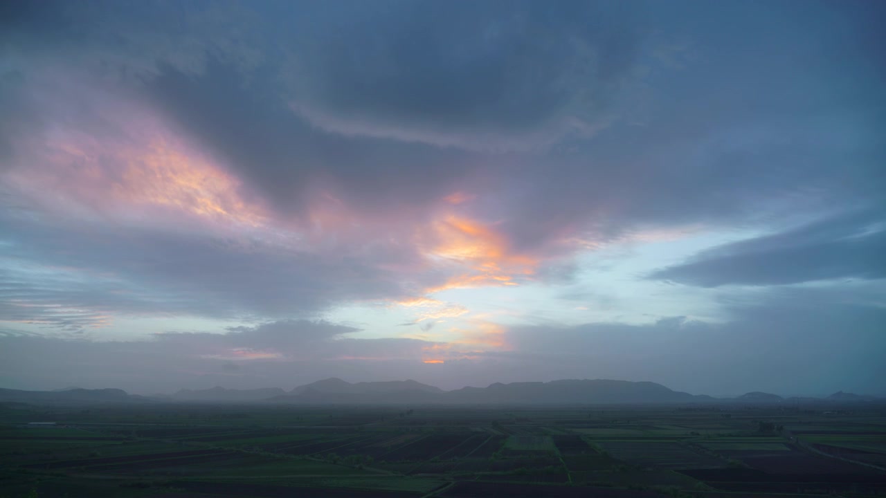 Time Lapse of Sunset Over Rural Landscape and Mountains