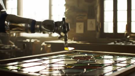a robotic arm skillfully assembles a stained glass masterpiece, showcasing the intersection of artistry and technology in craftsmanship
