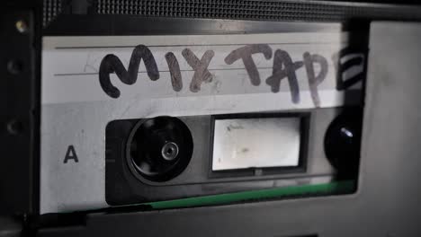 cassette tape. vintage tape recorder plays audio cassette tape inserted therein. mix tape.