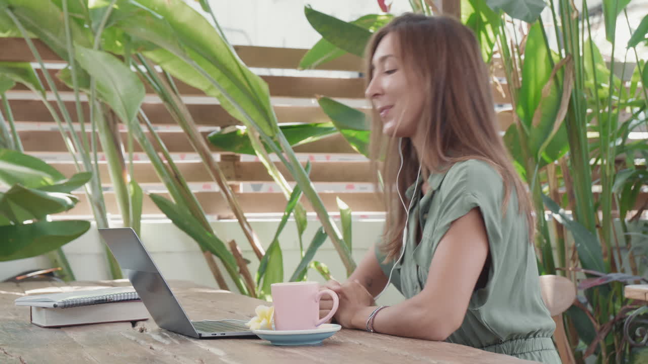 Woman Video Calling in Cafe Outdoors