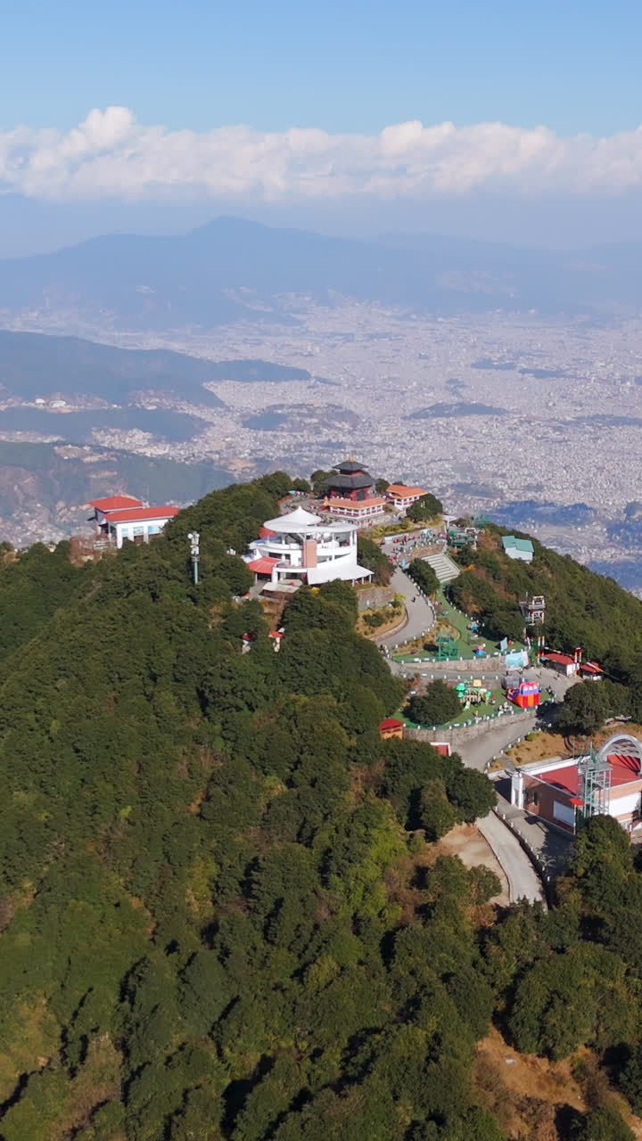 Portrait aerial of temples on the Chandragiri hill, in sunny Kathmandu, Nepal