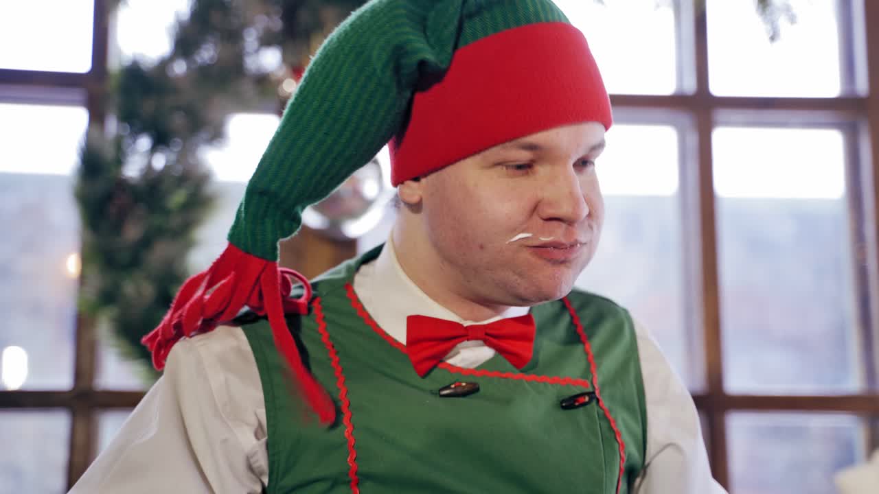 Portrait of eating elf. View of elf enjoying of Christmas dinner