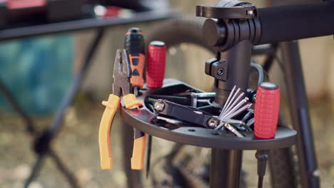 bicycle tools arranged on repair-stand