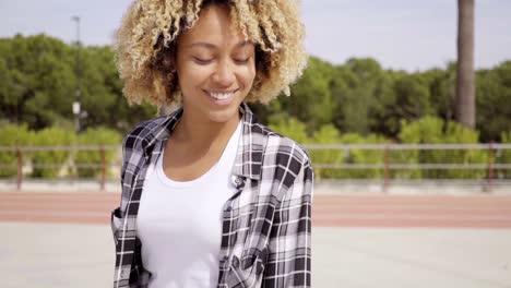 One-young-female-skater-walking-with-board-in-hand