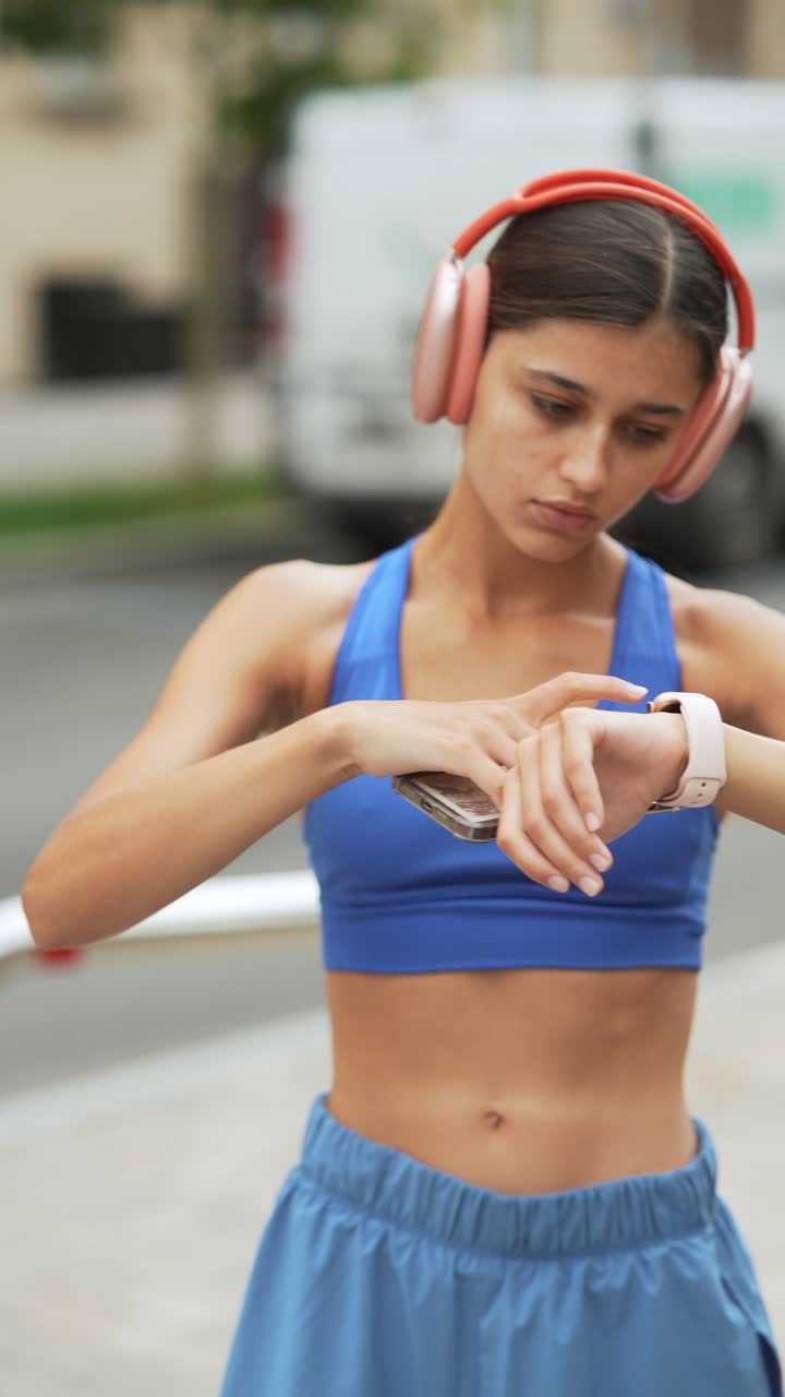 Woman Checking Smartwatch and Phone Outdoors