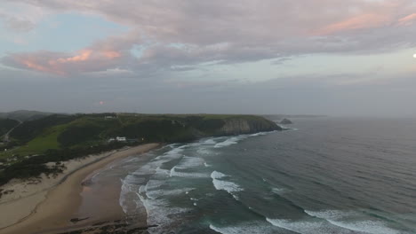 cinematic aerial flying at sunrise over coast of east london south africa