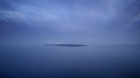 wide drone shot flying over lake michigan towards the uninhabited little summer island