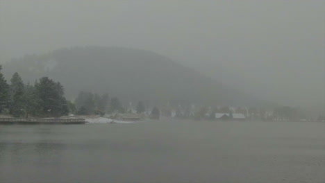 Downtown-Evergreen-Lake-house-foggy-Colorado-historic-downtown-aerial-drone-blizzard-fall-autumn-winter-first-snowfall-colorful-aspen-trees-Rocky-Mountain-front-range-Denver-backward-slowly-motion