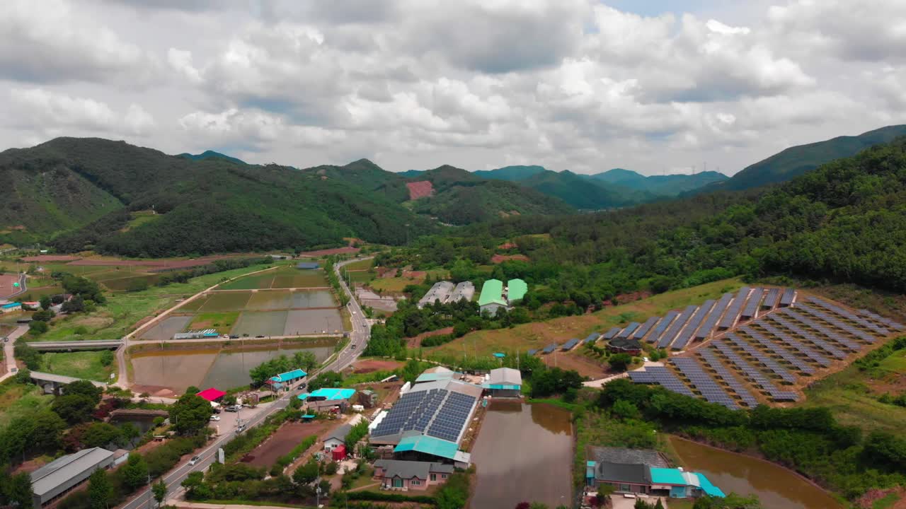 High altitude lateral slide aerial view of solar power plant and country side