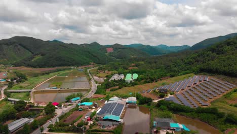 high altitude lateral slide aerial view of solar power plant and country side