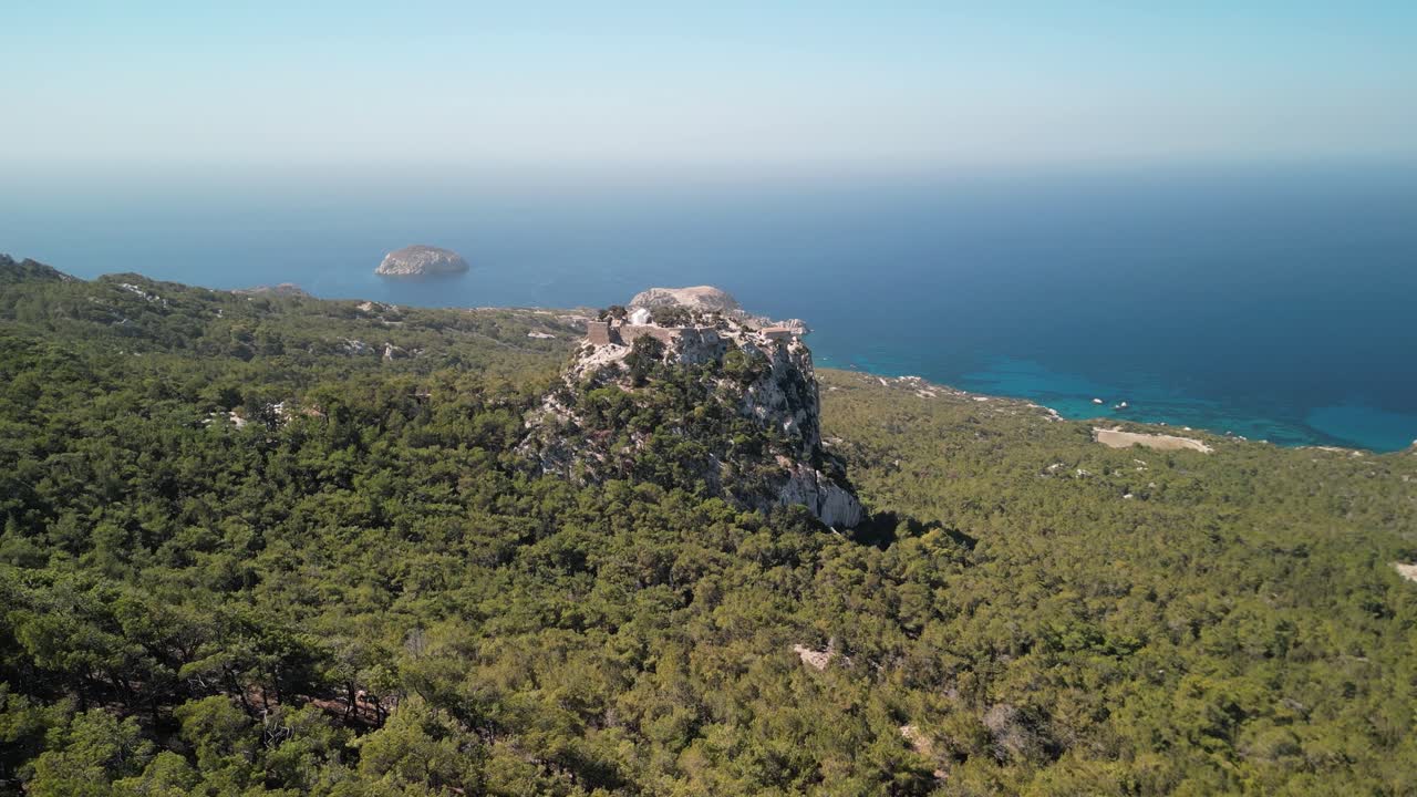 Stunning Monolithos Castle aerial drone rise up and reveal coast, Rhodes, Greece