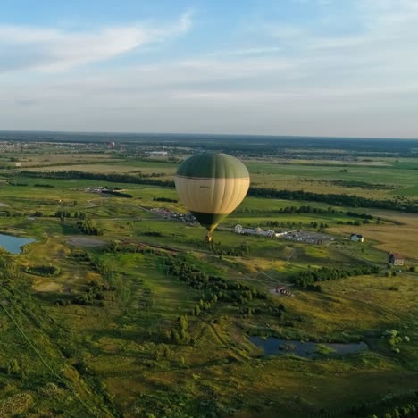 colorful aerostats among nature. hot air balloons fly in the sky over fields and lakes in the countryside. aerial view.