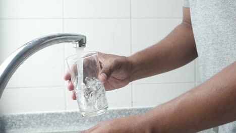 water pouring from a faucet tap slow motion