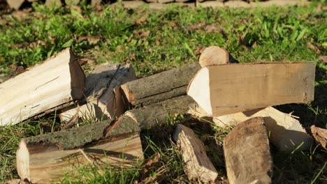 Woodpile-stack-while-chopping-wood-for-winter,-cutting-firewood-with-axe