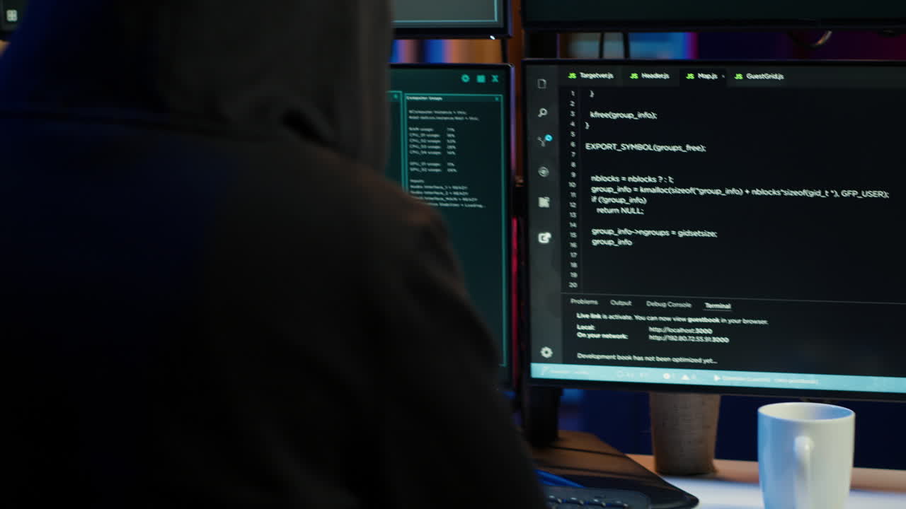 Close up of hacker running code in apartment on PC monitors