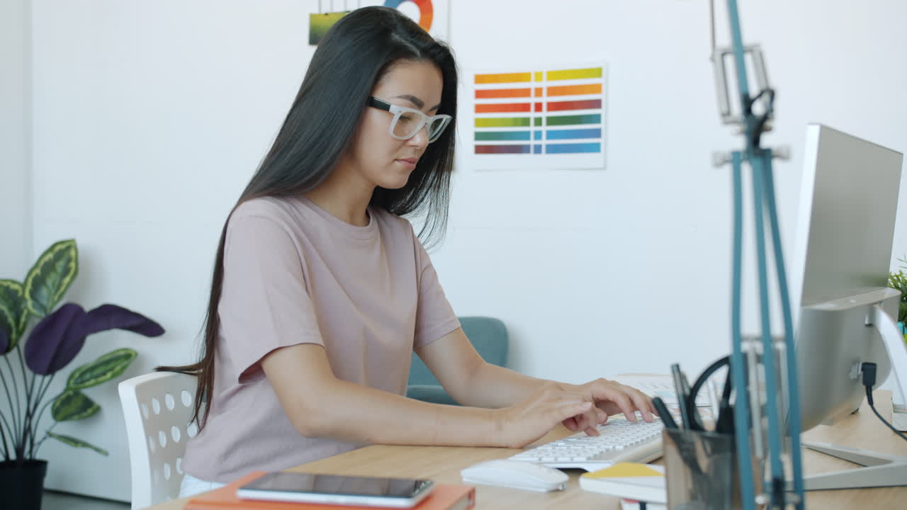 Woman Working on Computer in a Modern Office