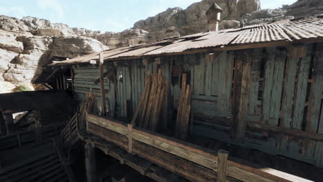 abandoned wooden shack in a mountain valley