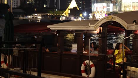 crew prepares riverboat for evening service on urban river